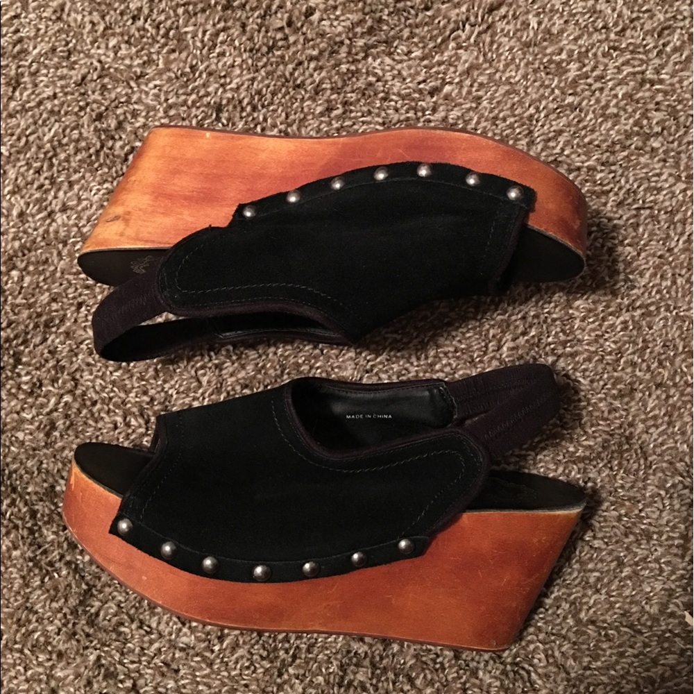 Black clog sling back platform sandals.