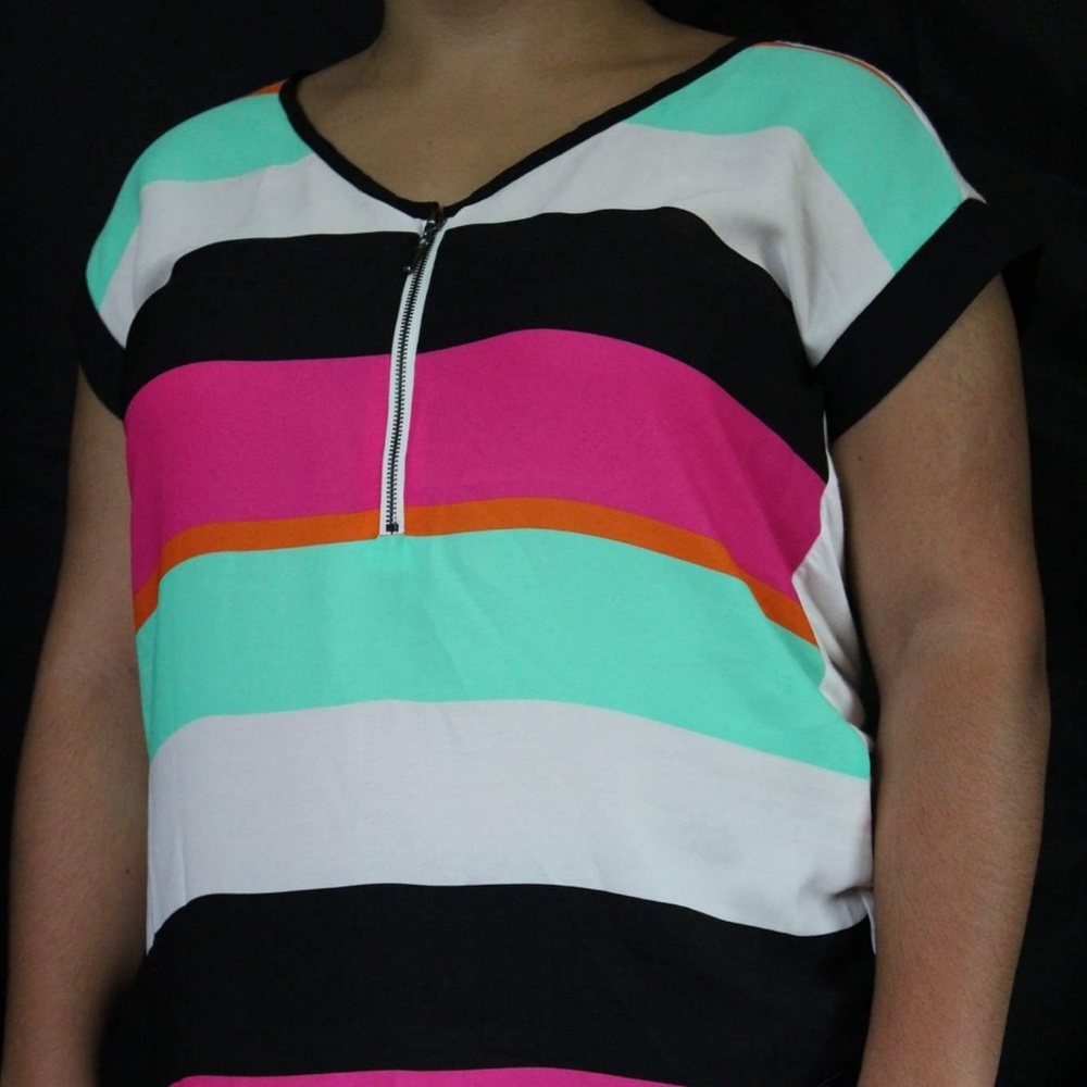 Green, pink, black and white shirt.