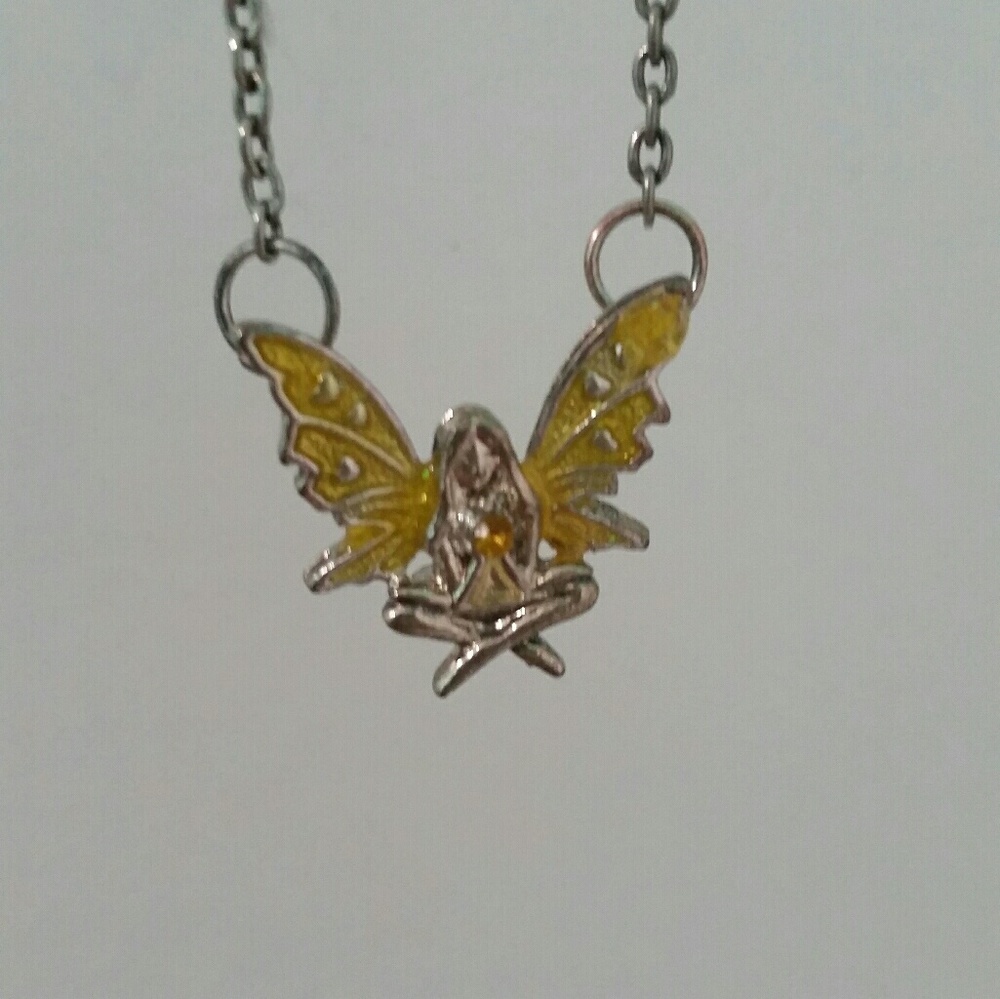 Sitting fairy holding yellow gemstone necklace
