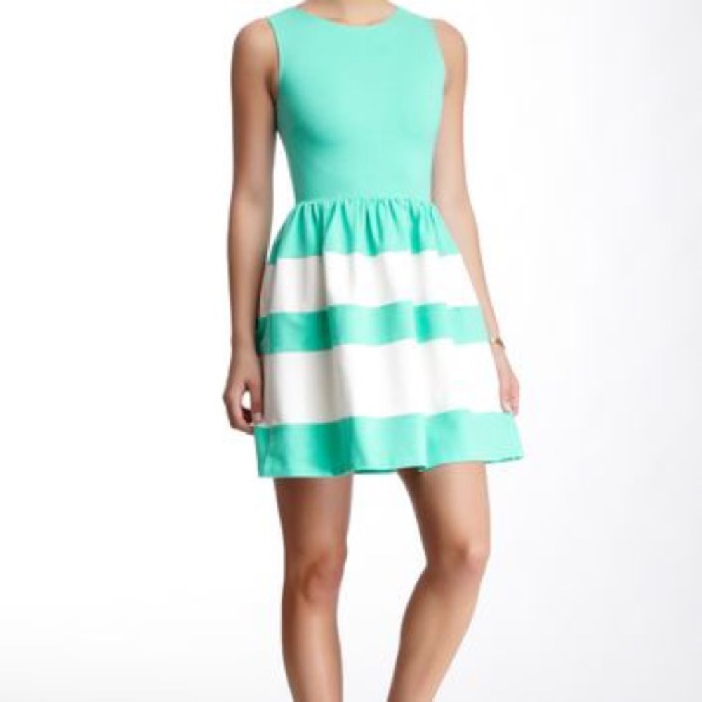 Turquoise and white sleeveless dress.