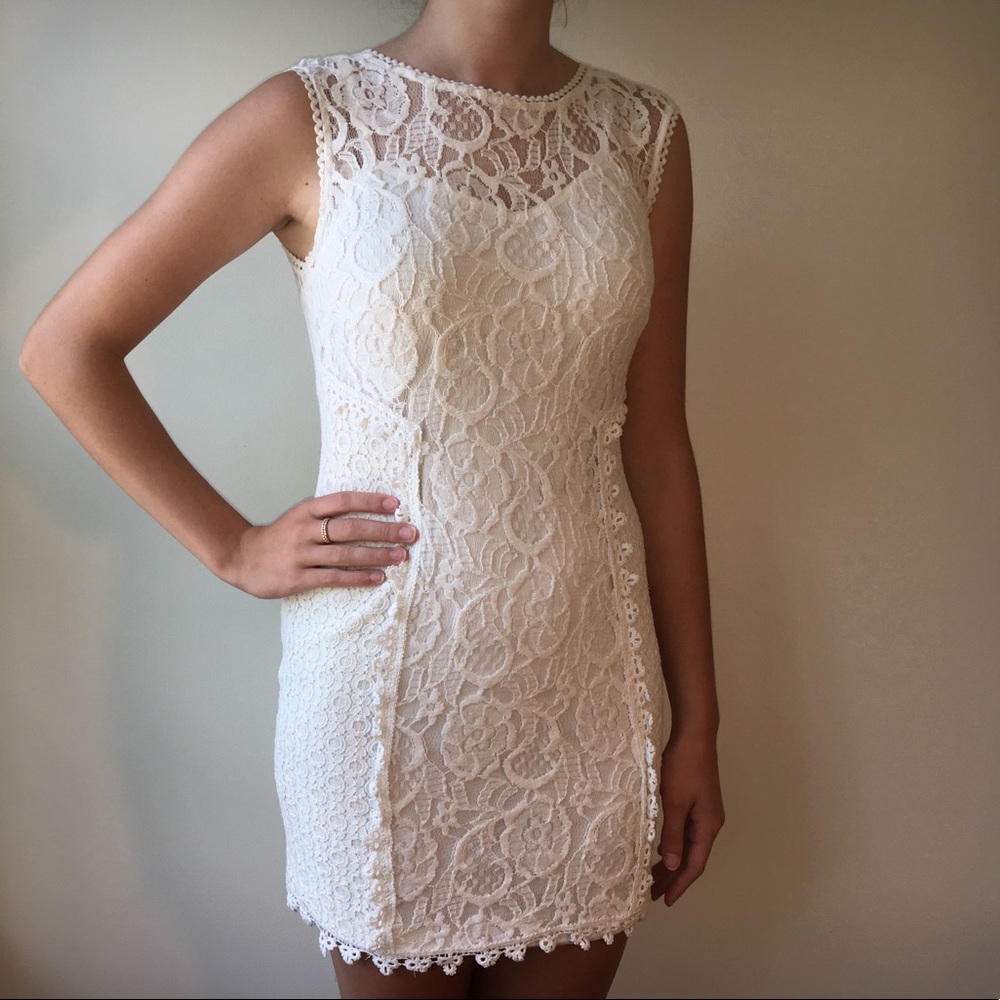 All white and tight sleeveless lace dress