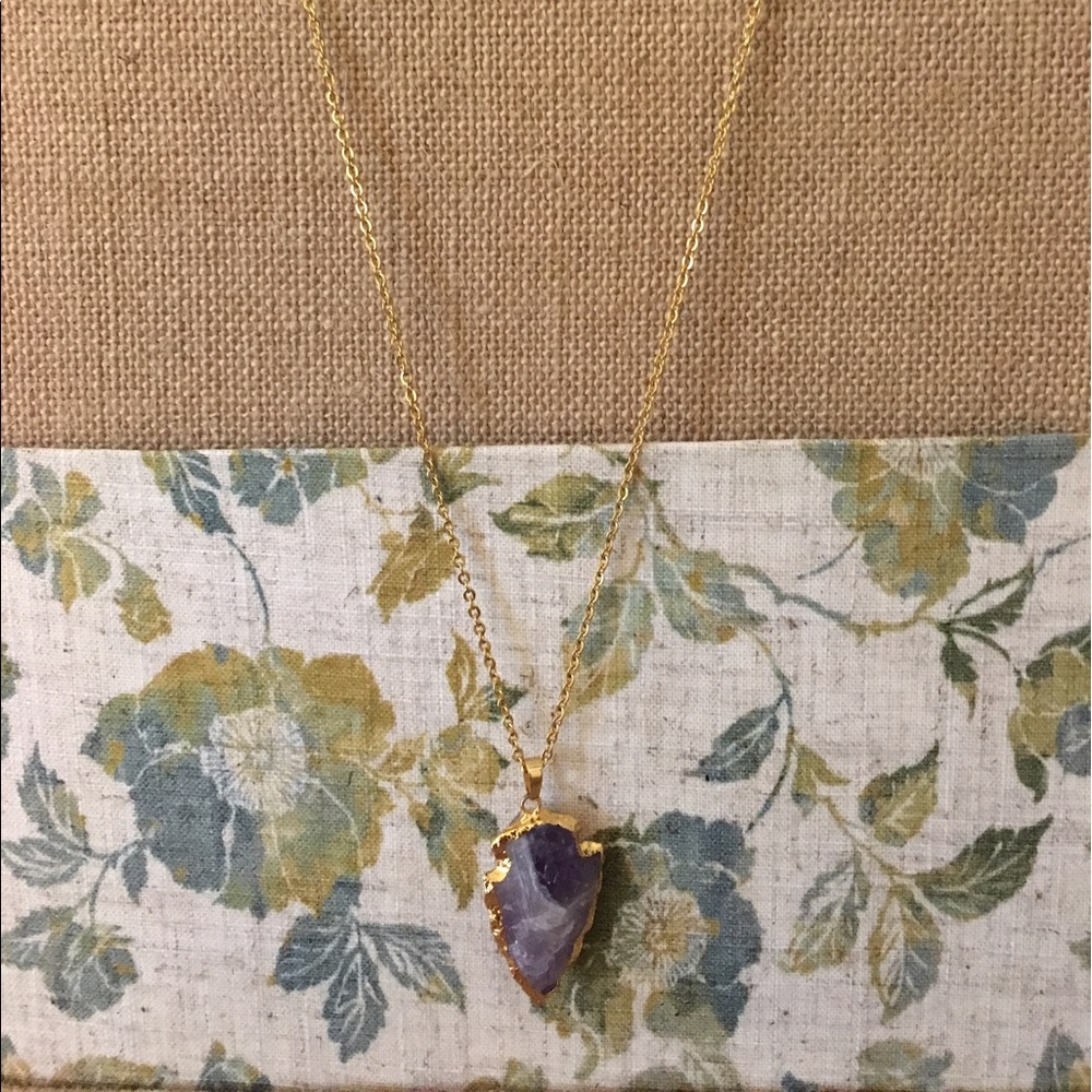 Faux amethyst arrow pendant with gold chain.
