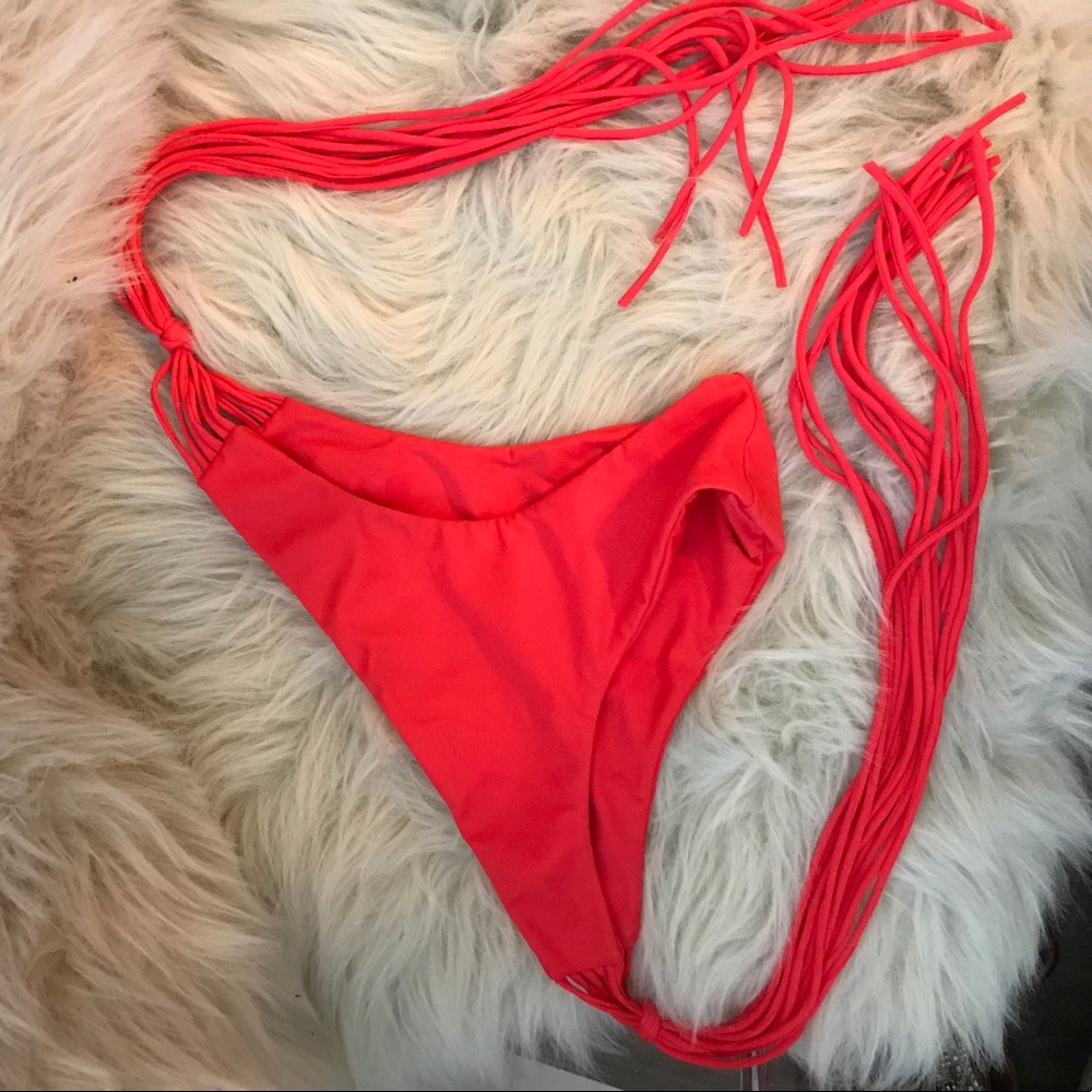 Mikoh orange tie side adjustable swim bottoms.