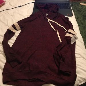 A long sleeved sweater shirt with hood.