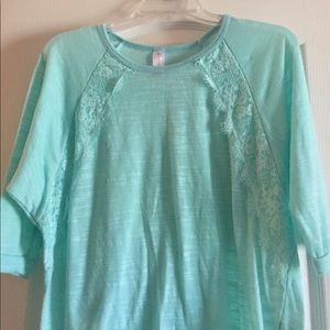 A turquoise see through shirt
