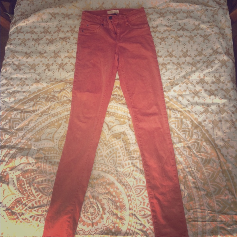 High waisted, stretch jeans in the color orange