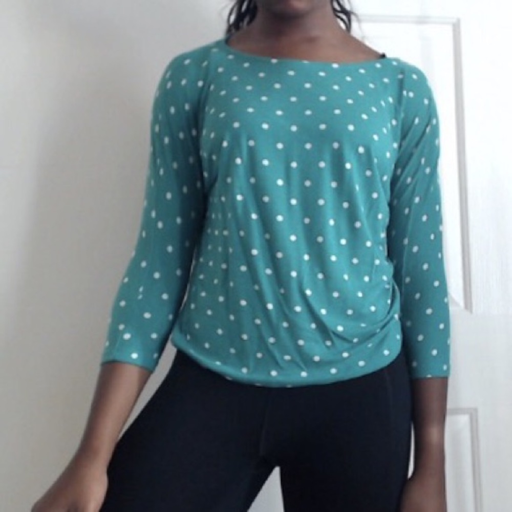 Teal shirt with white polka dots