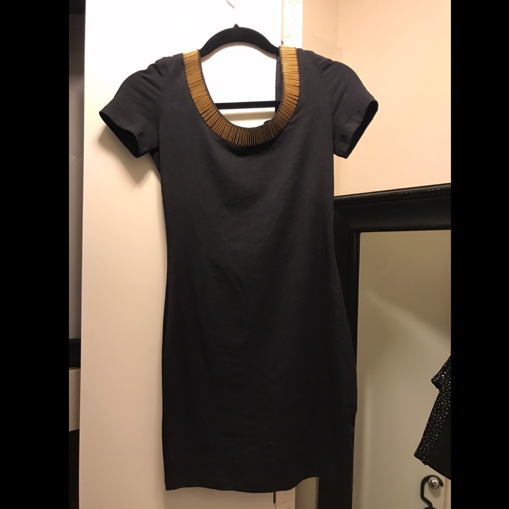 Black low back dress with gold metal detailing