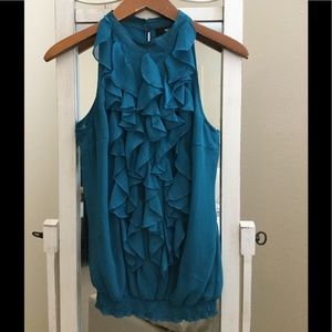 Ruffled sleeveless blouse.