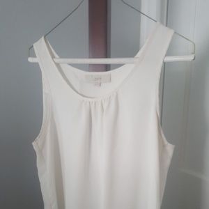 Cream colored shell with lace hem detail