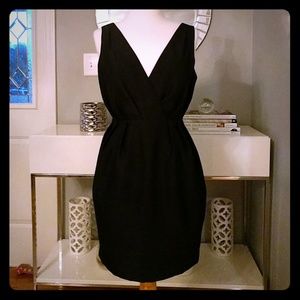 Form fitting low cut black dress