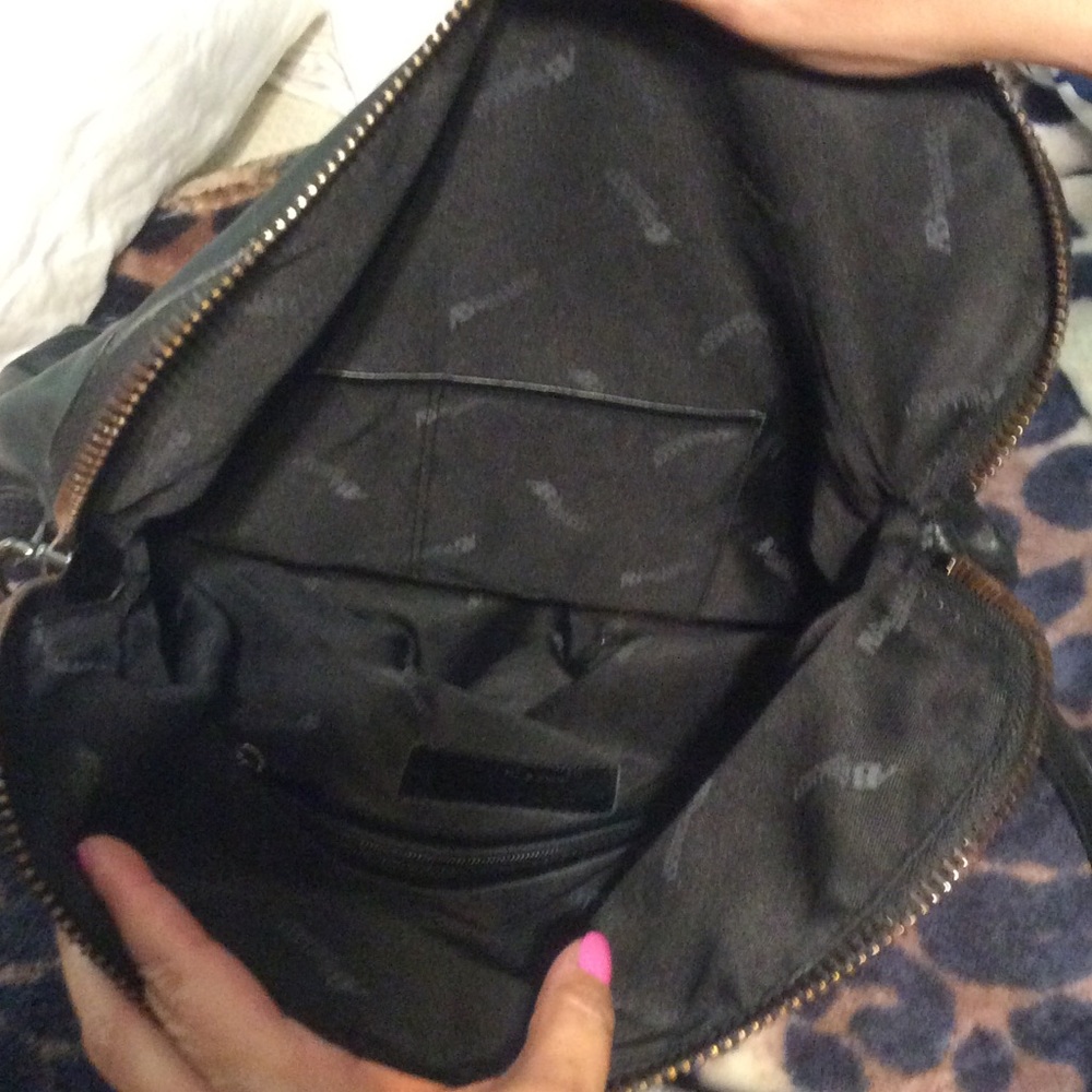Black leather purse Folds. Long leather strap.