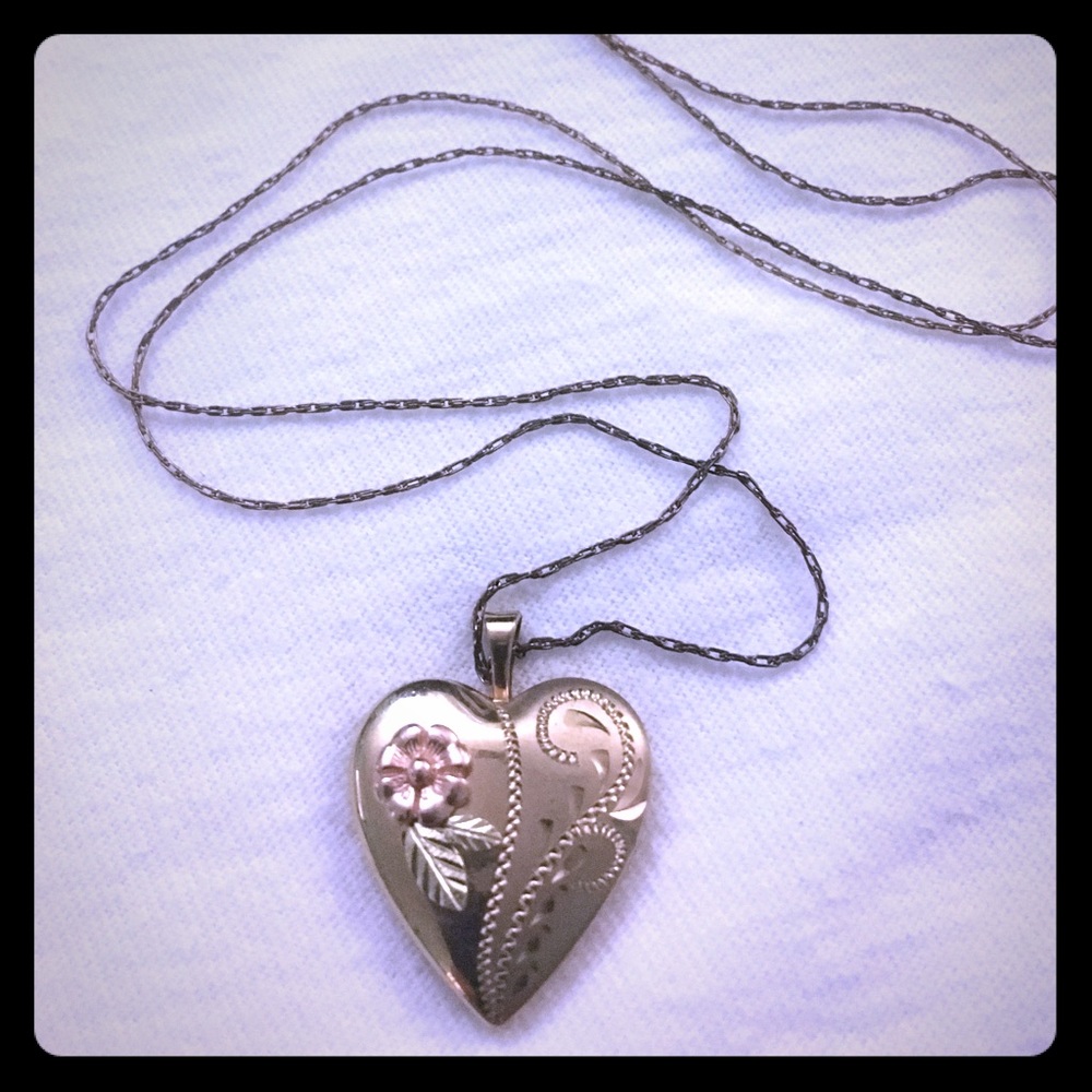 Gold vintage locket with rose and vine detail.