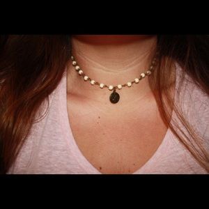 White beaded necklace with coin charm