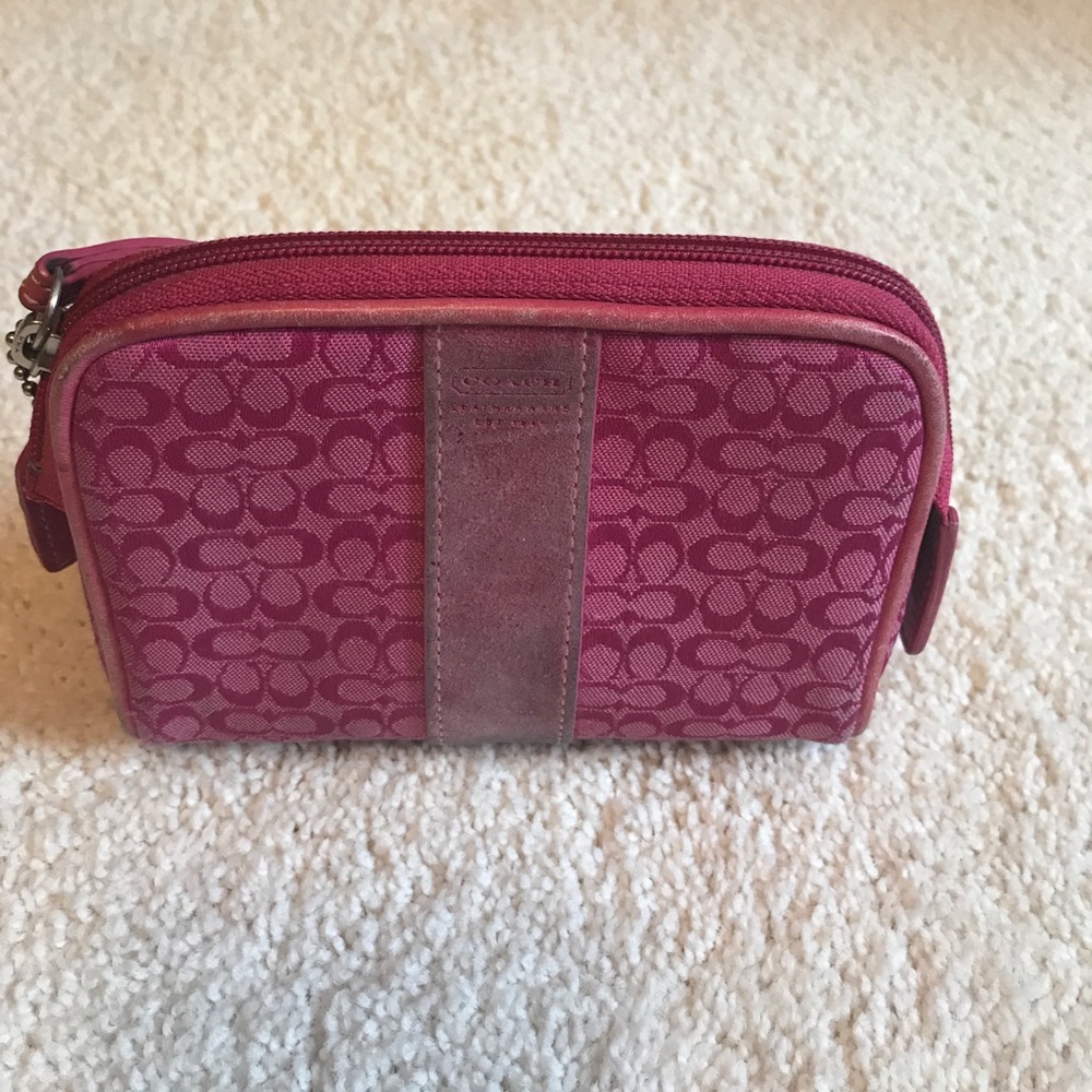 Hot pink Coach mini cosmetic bag.