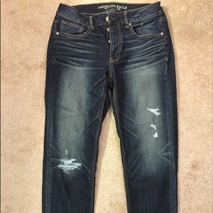 Distressed dark boyfriend jeans. Worn rolled up