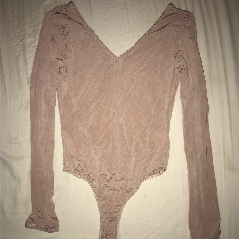 A cream pink long sleeve one piece