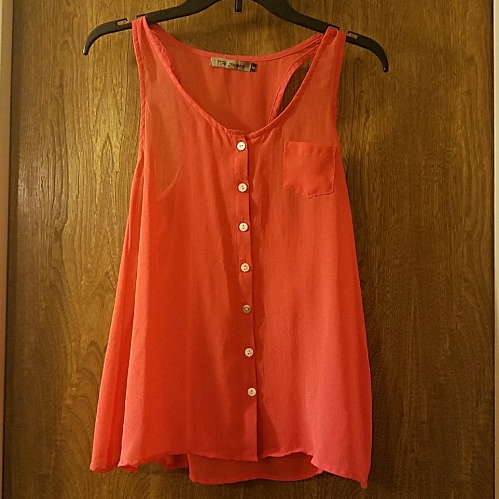 Cute coral colored high low racer back tank top.