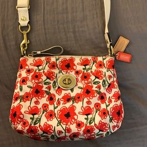 A Coach floral cross body purse.