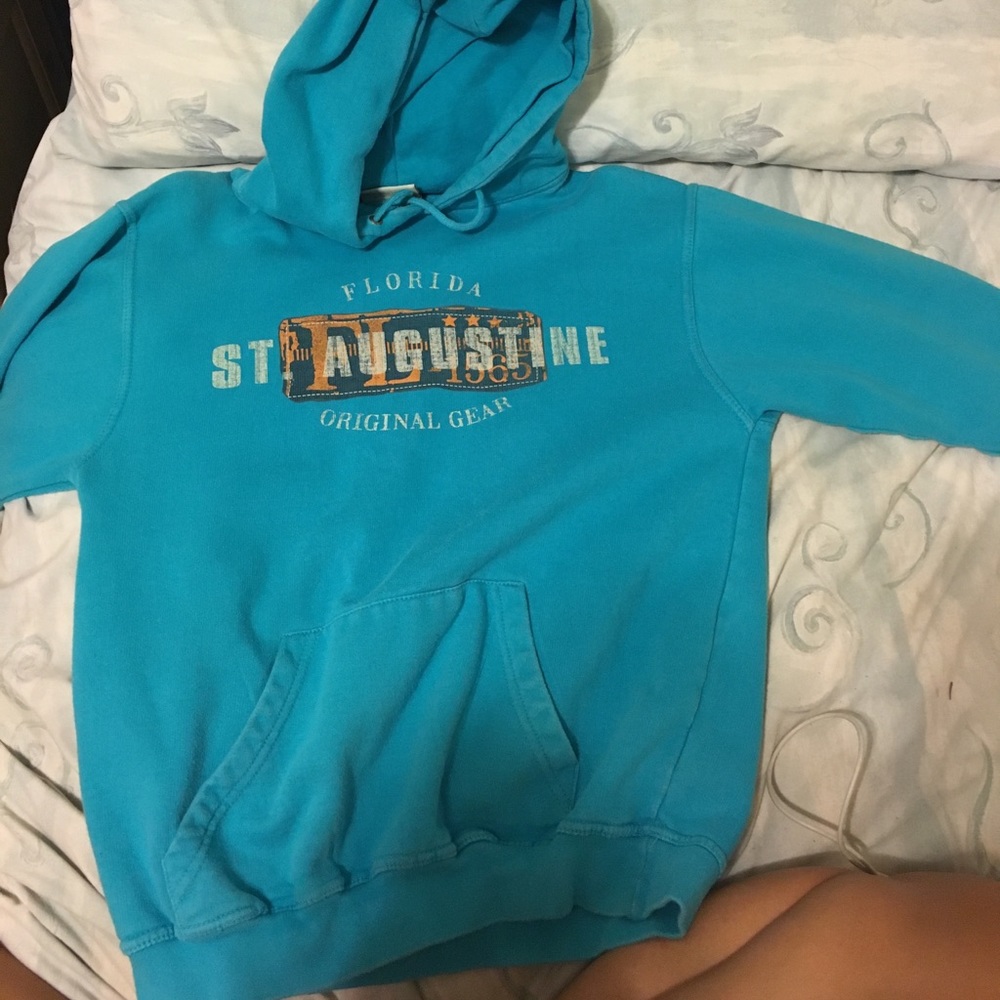 A teal blue pullover