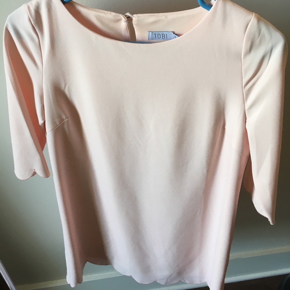 Pink dress with scalloped sleeves and bottom