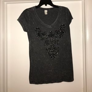 Black t-shirt with fleur de lis design.