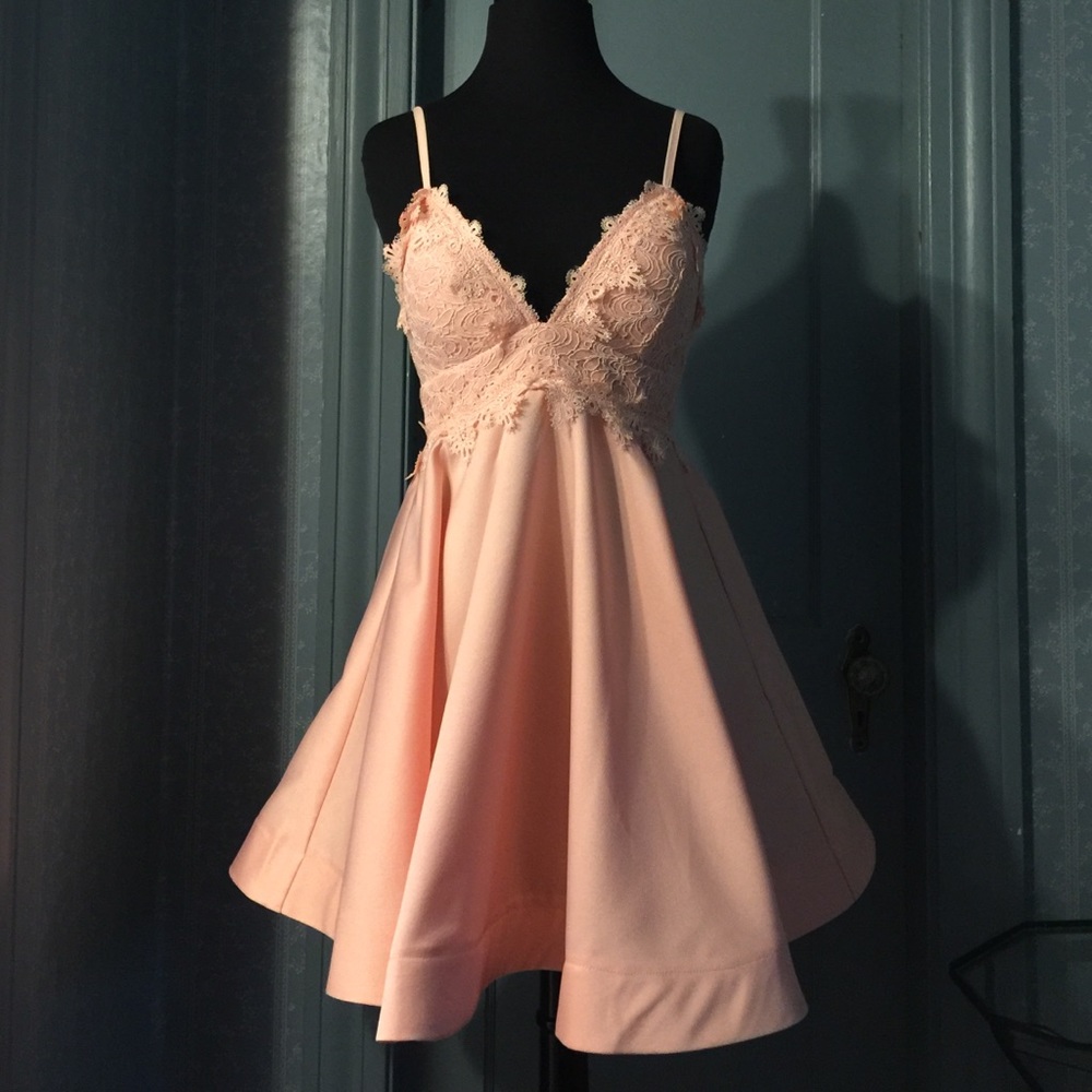 Peach swing mini dress with lace detailed top.