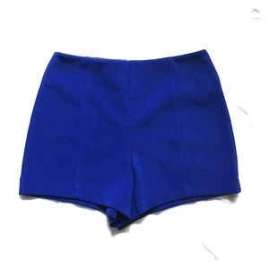 High waisted, blue shorts.