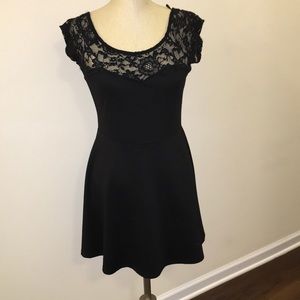 Size Large black dress with lace detail.