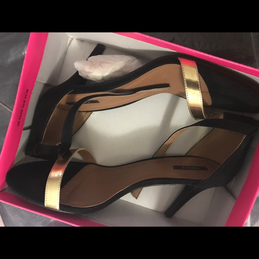 Black heels with a gold strap in the front
