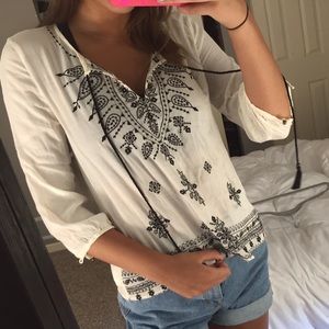 A white flowy blouse with embroidery