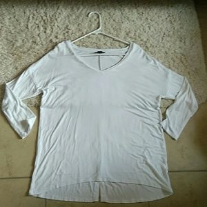 Plain white top with 3/4 sleeves, and V neck style
