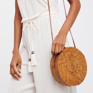 Large round rattan bag with leather strap and clip