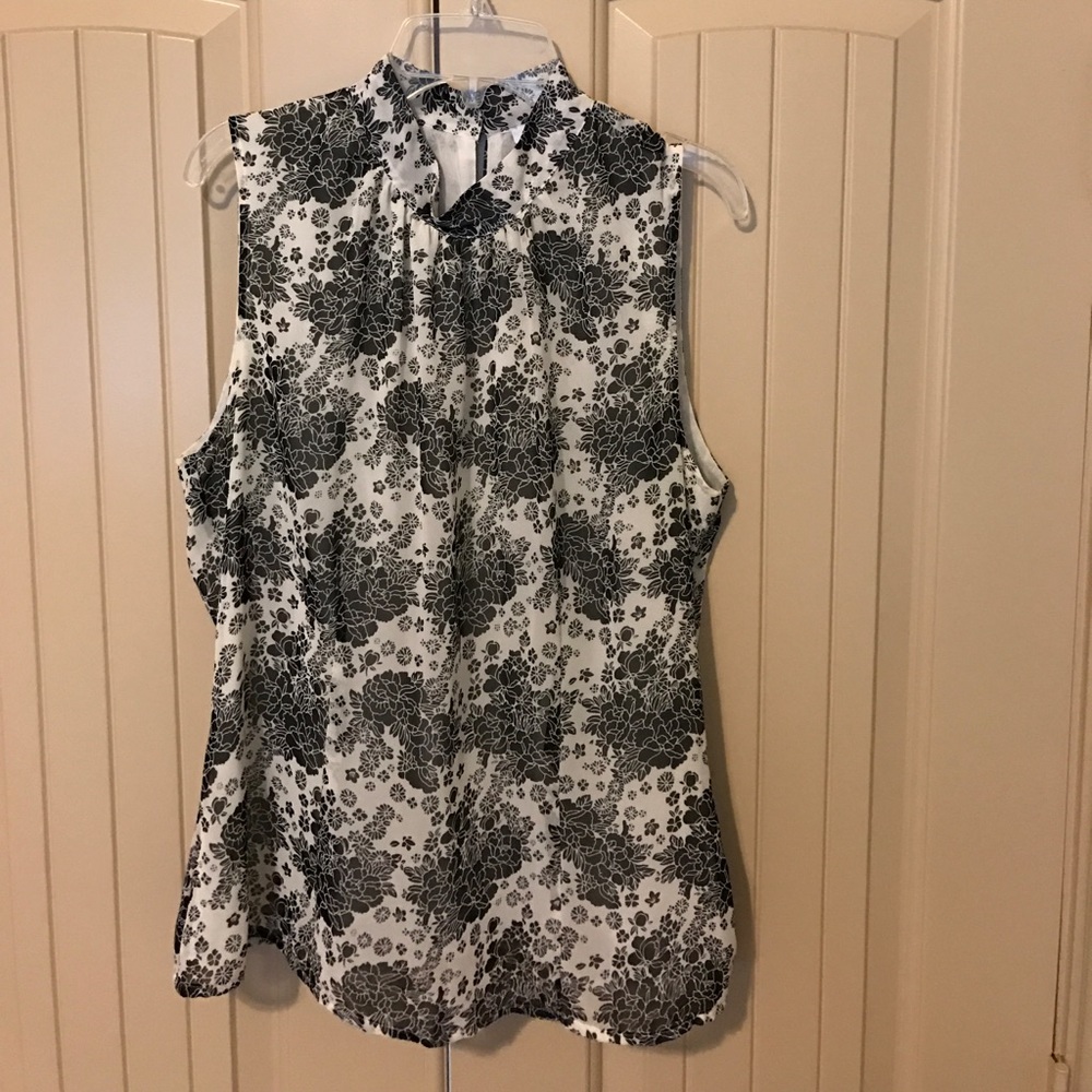 Sleeveless mock neck blouse.