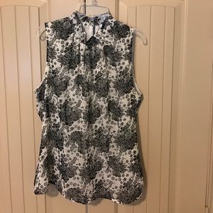 Sleeveless mock neck blouse.