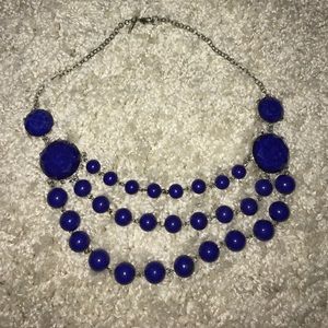 Navy blue bead necklace.