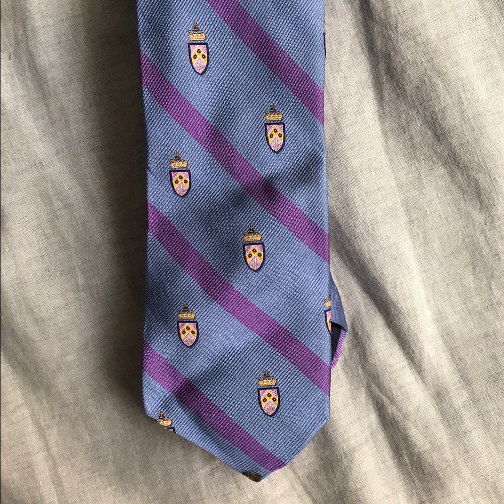 TALL TIES by Peter Field; purple patterned crest.
