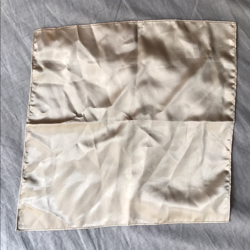 Cream colored silk pocket square.