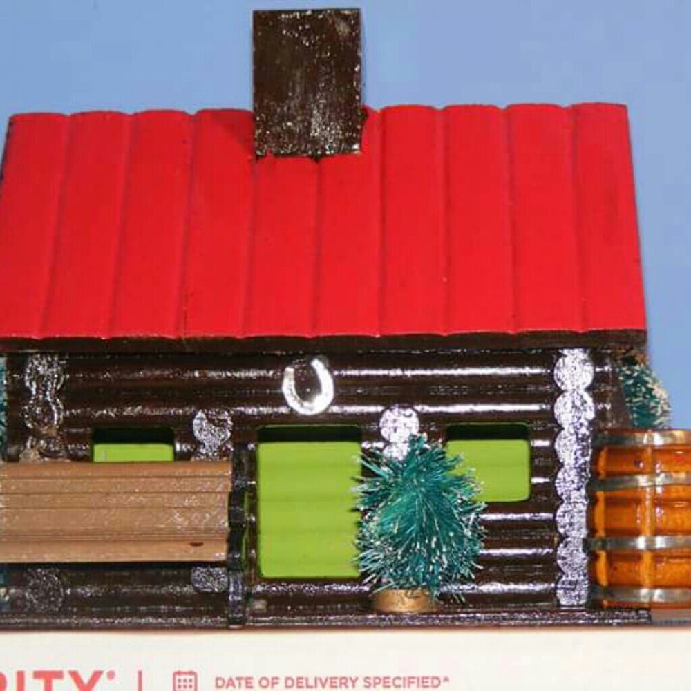 Decorated log cabin bird house