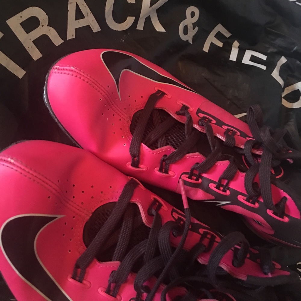 Used pink Nike track spikes