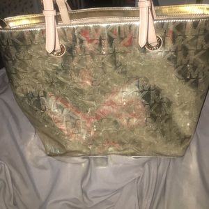 A gold Michael Kors purse