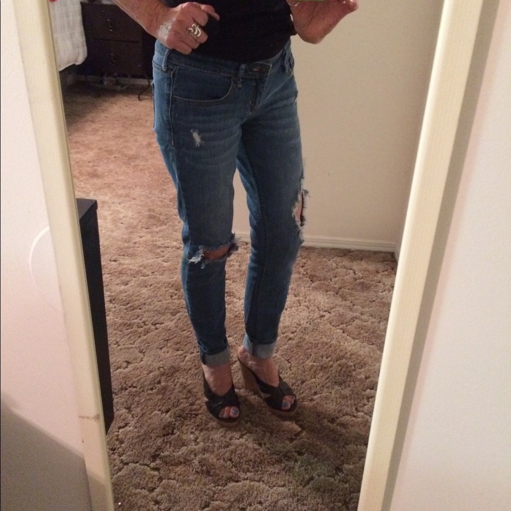 Fashionable blue jeans with torn knees