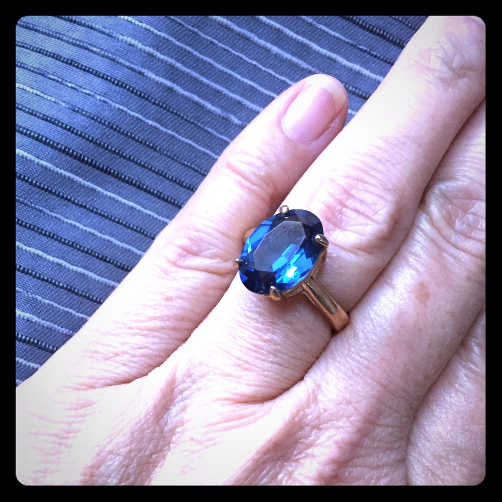 Sapphire blue colored oval gemstone gold band ring
