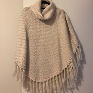 Cable knit poncho with fringing detail