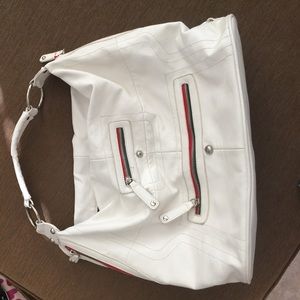 White large purse with green and red zippers