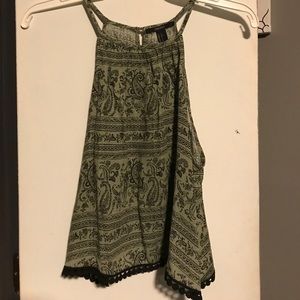 Green and black blouse with pom poms