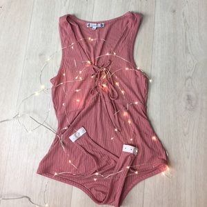 Lace up bodysuit. Never worn.