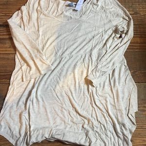 Cream colored maternity top with gold sparkles