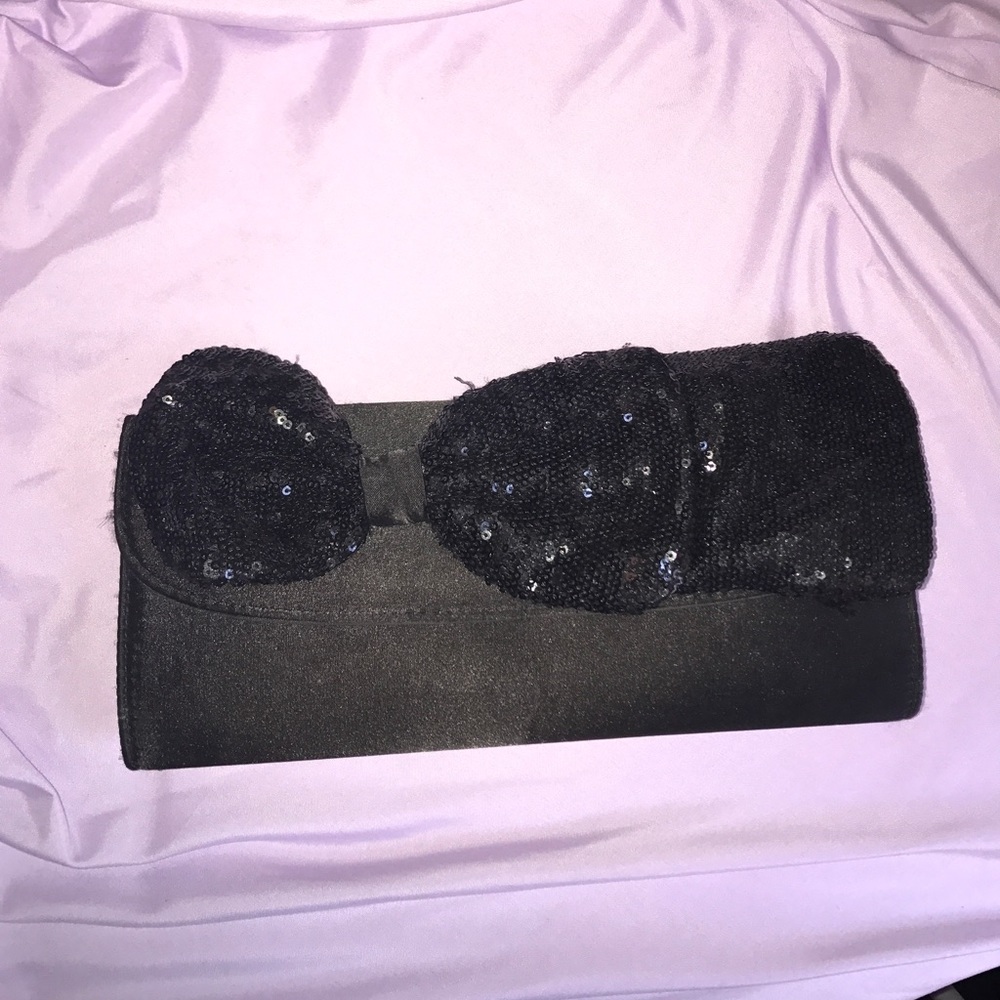 Black clutch with sequin bow tie.