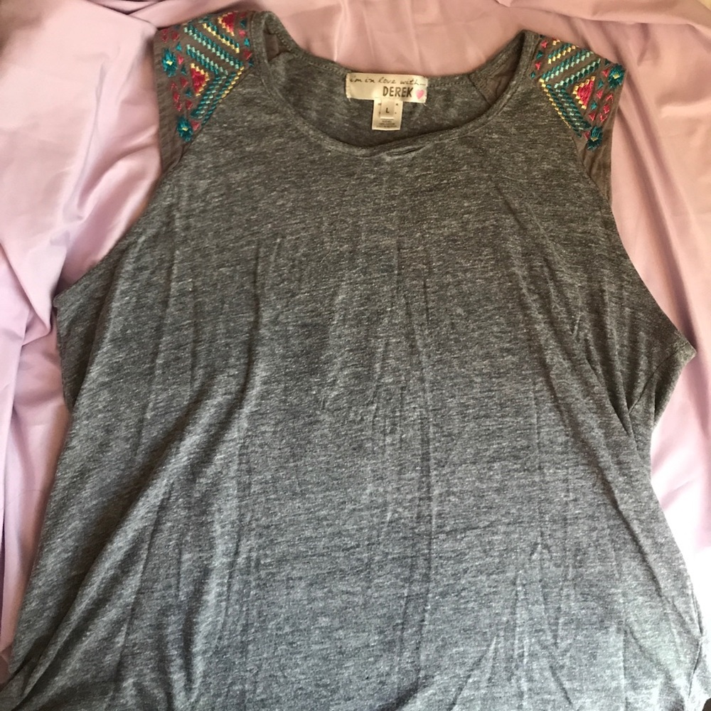 Gray muscle tee with embroidered sleeves.